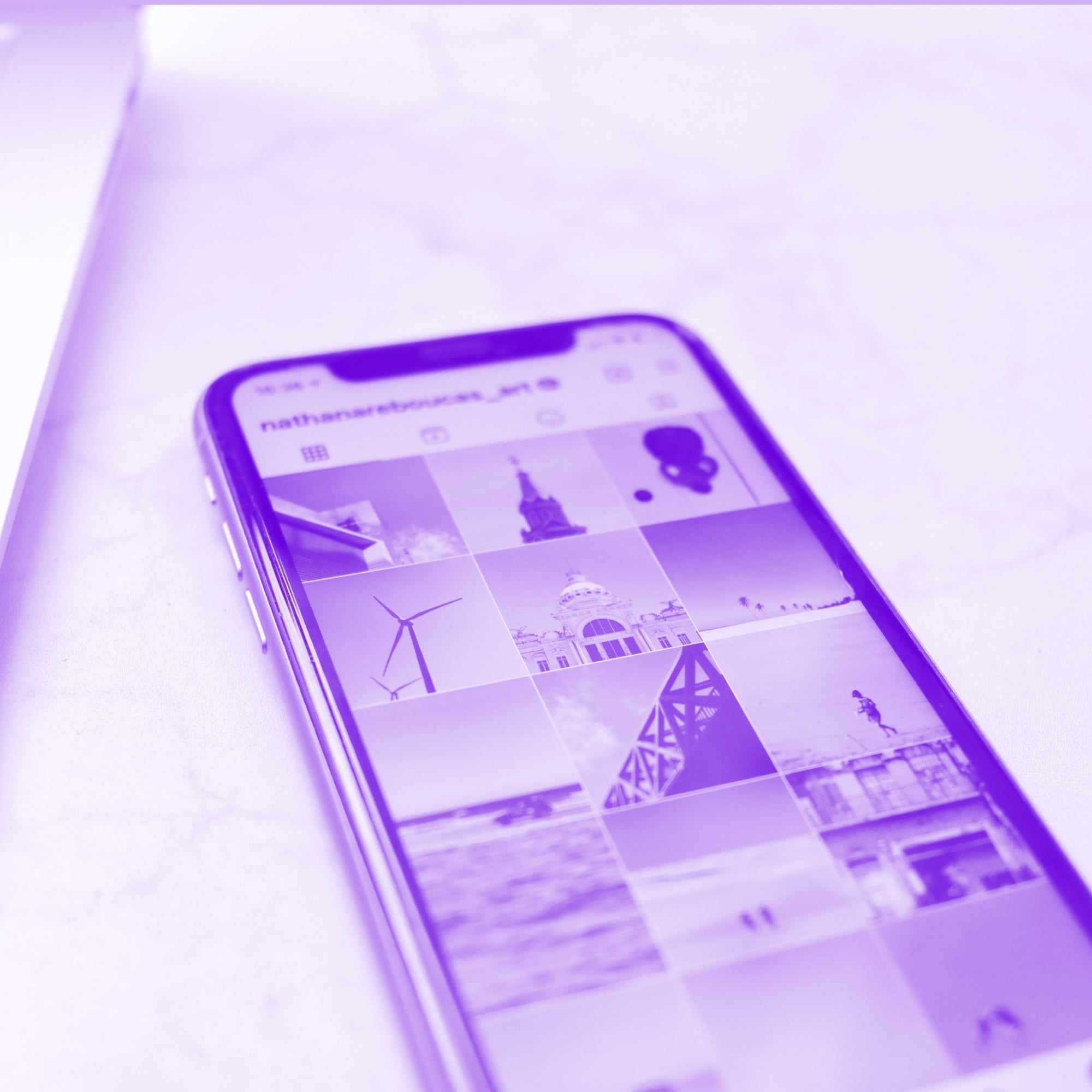 iphone showing instagram profile grid purple toned