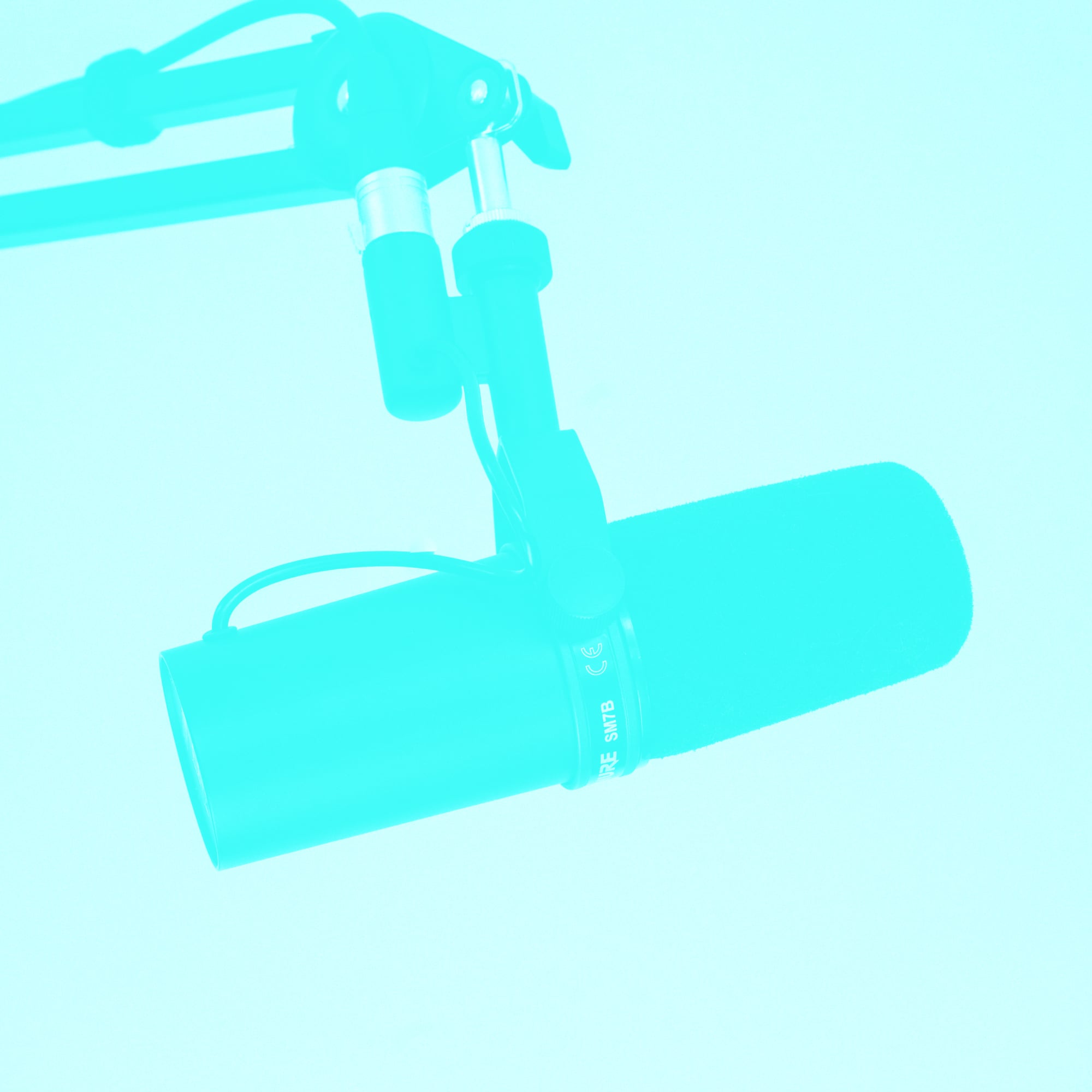 shure sm7b podcast microphone on boom arm teal background