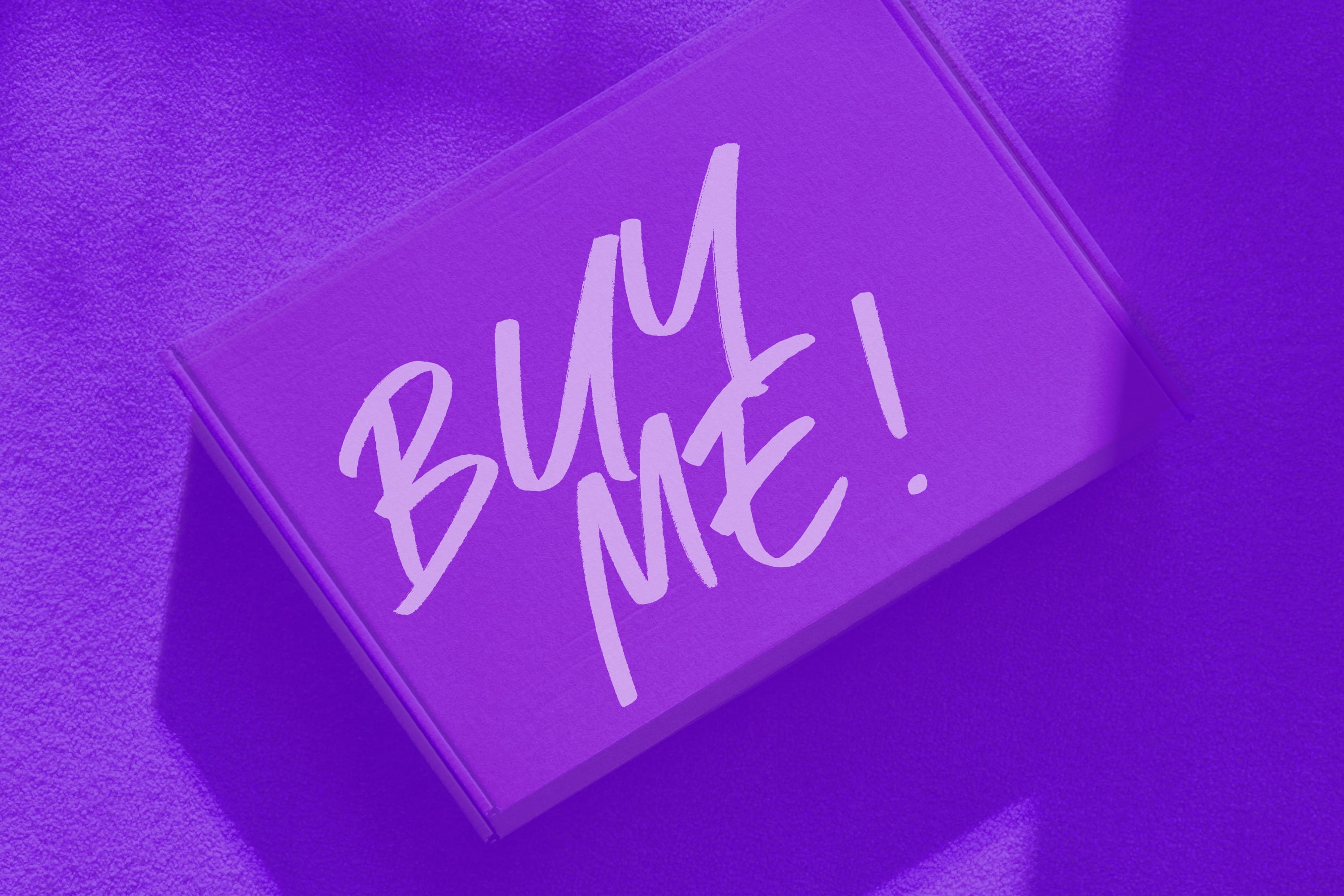 glossy purple gift box with buy me handwritten text purple background