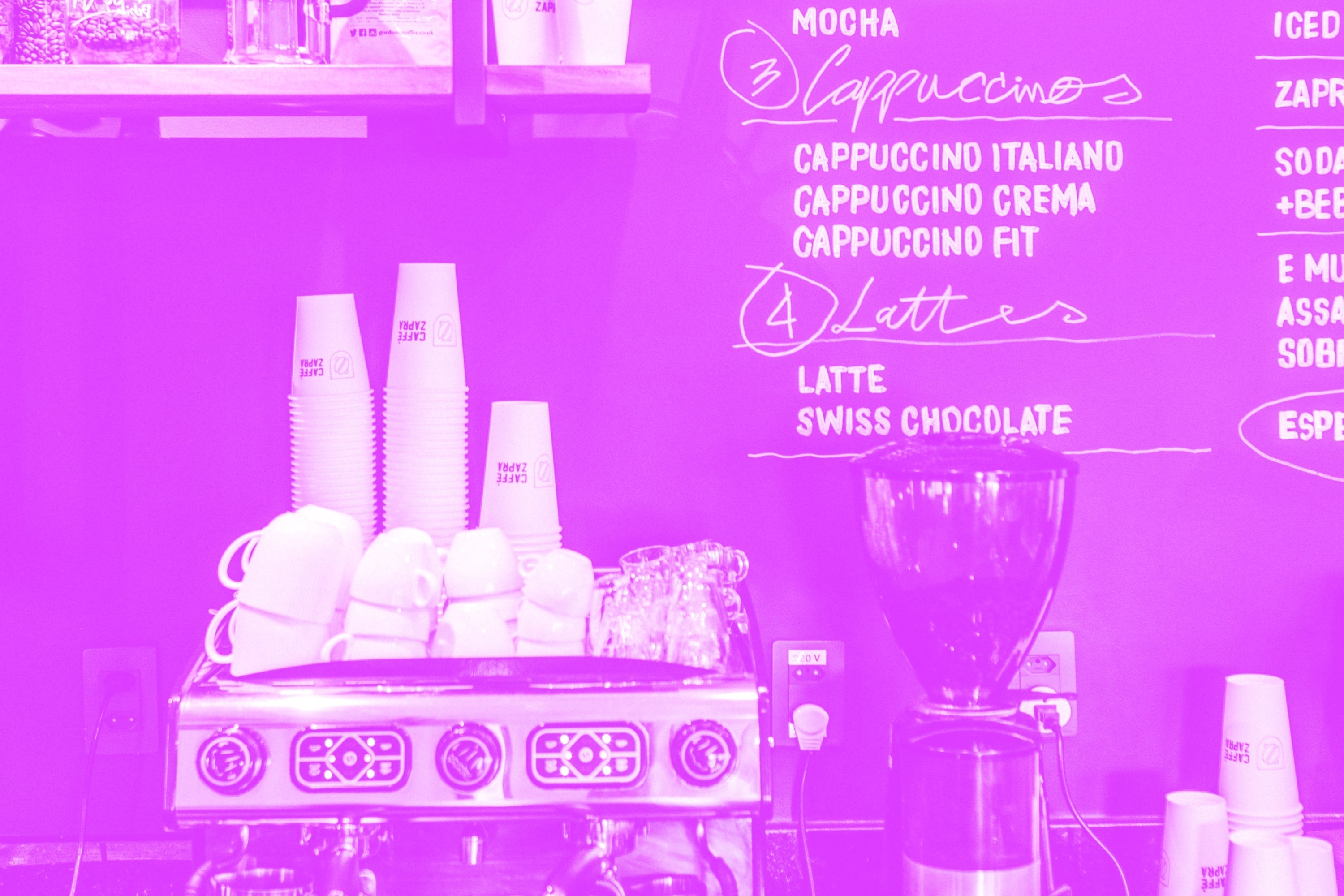 espresso machine and coffee shop counter with chalkboard menu cappuccinos lattes pink purple