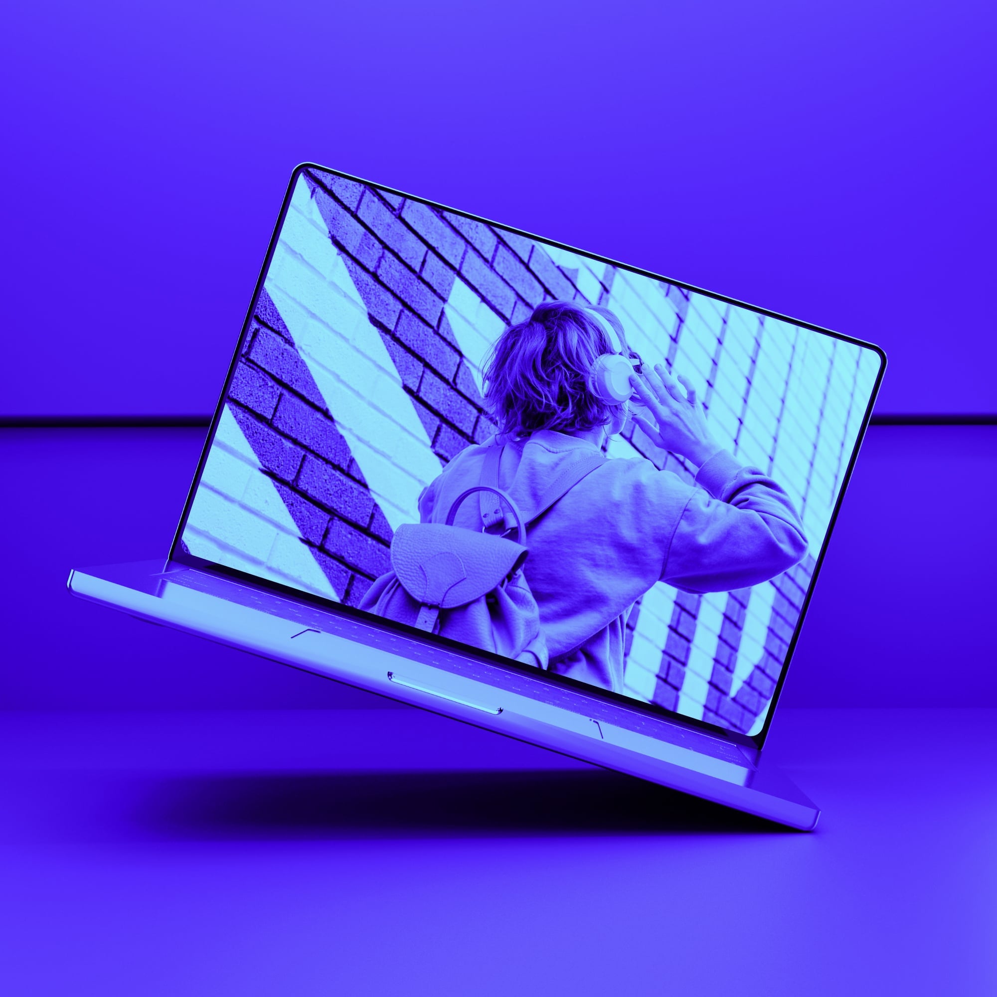 floating macbook laptop showing person with headphones and backpack blue purple toned