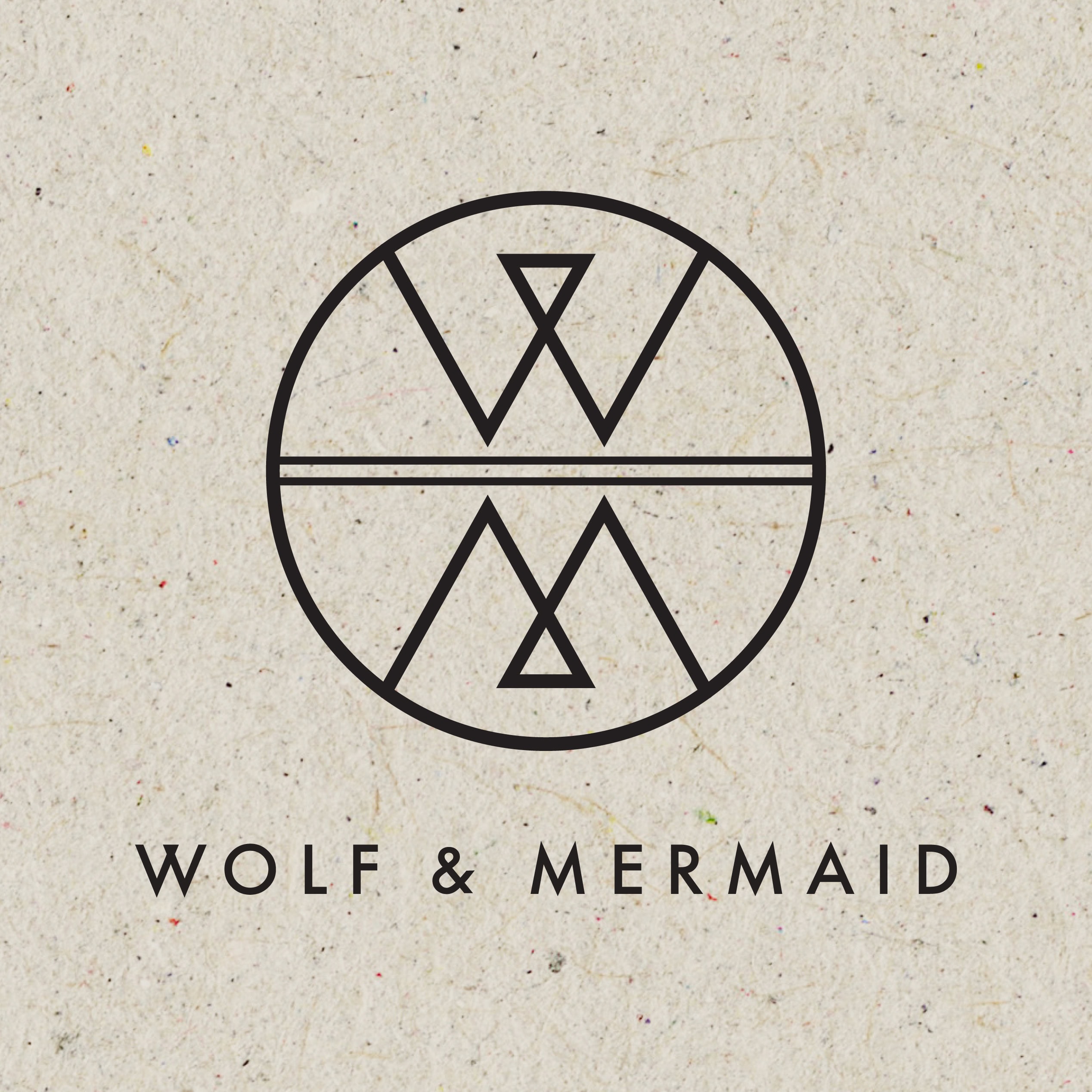 Wolf & Mermaid circular logo and wordmark printed on speckled recycled paper