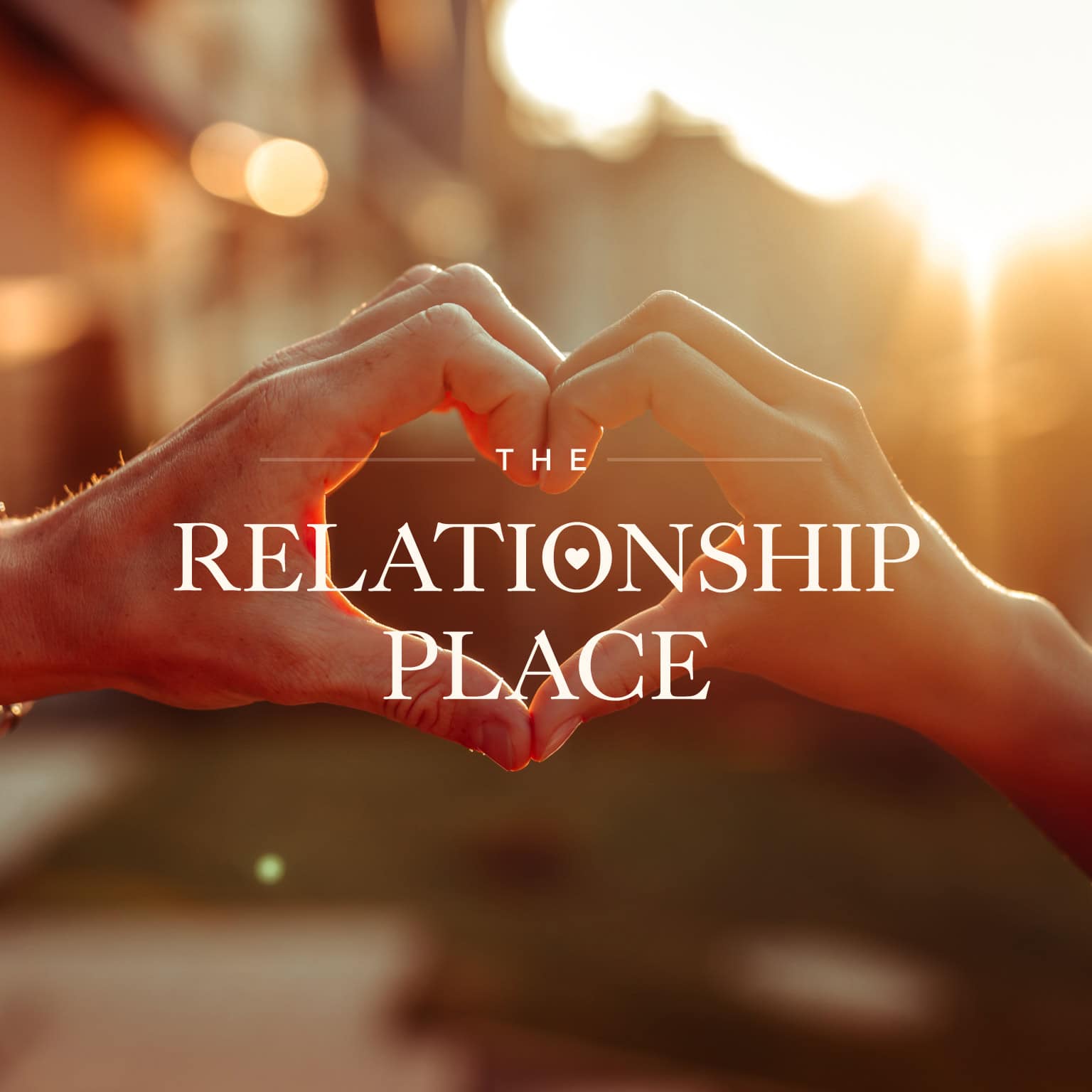 Two hands forming a heart shape against a sunset background with The Relationship Place branding overlayed in white
