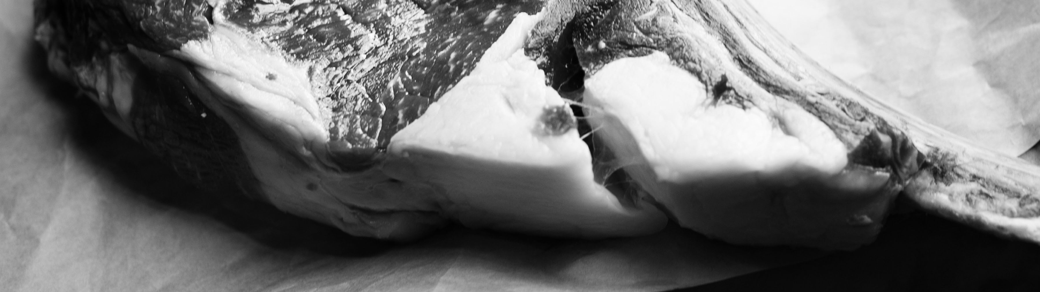 Close up of raw rump steak on rustic wooden board